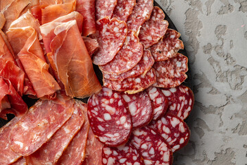 Wooden platter with meat cuts close up