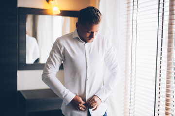 Fototapeta premium Gathering of the stylish groom at the hotel in the apartment