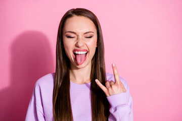 Photo of attractive funky cool youngster lady protrude tongue mouth show finger horns crazy rock...