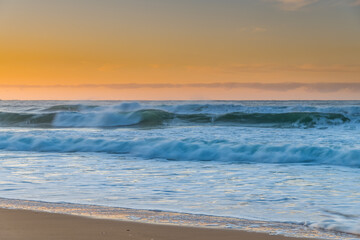 Fototapeta na wymiar Winter and Waves - Sunrise at the Seaside