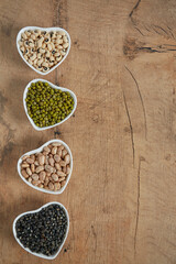 assortment of beans on wooden surface
