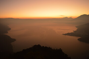 Fototapeta premium Sunrise over the volcanoes of Lake Atitlan in Guatemala, Central America