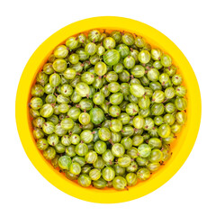 Ripe green gooseberries in yellow bowl. Photo