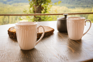 Tasty coffee served in the garden on old wooden table