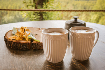 Tasty coffee served in the garden on old wooden table