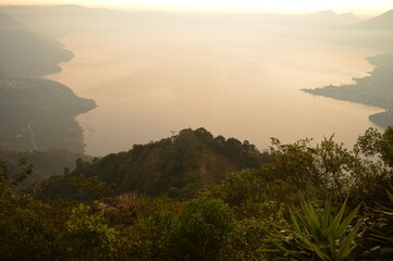 Fototapeta na wymiar Sunrise over the volcanoes of Lake Atitlan in Guatemala, Central America