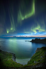 Beautiful night sky with Aurora Borealis aka northern lights in the fjords in Norway.