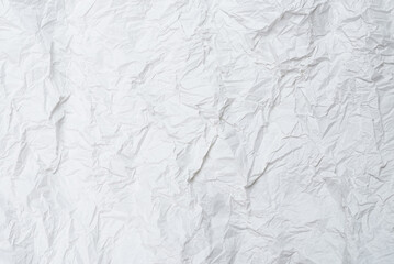 Crumpled white paper background.