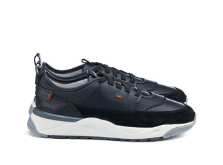 Pair of elegant lightweight men's sneakers made of natural perforated leather, trimmed with suede, and white rubber sole. Side view.