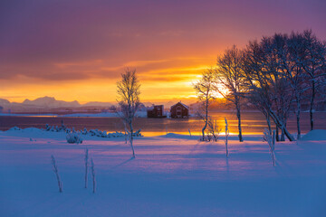 Moody sky winter sunset blue hour over the red houses in Norway