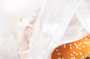 Fototapeta na wymiar Cheeseburger in wrapping paper closeup.