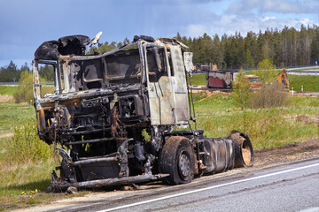 Fully burned truck on road