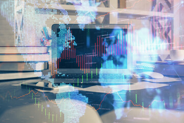 Financial graph colorful drawing and table with computer on background. Double exposure. Concept of international markets.