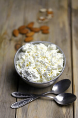 Fresh homemade cottage cheese in a bowl. Almond. Country style. Healthy food concept. Dairy.