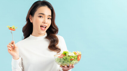 Smiling woman eating healthy salat