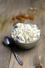 Fresh homemade cottage cheese in a bowl. Almond. Country style. Healthy food concept. Dairy.