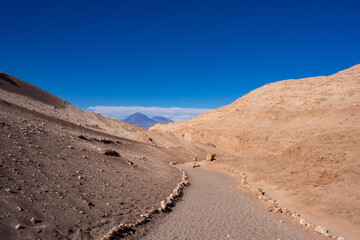 Fototapeta na wymiar Delimited path on a tour through the amazing Valle de la Luna. Atacama Desert, Chile.