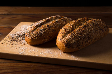 multigrain wholemeal bread with seeds on brown wooden table