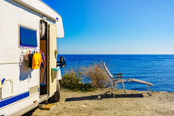Camper rv on sea with clothes to dry