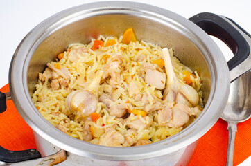 Pilaf with rice and meat in saucepan.