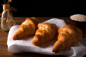 croissant on brown wooden table