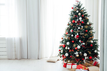 Christmas tree by the window with gift decor for the new year interior holiday card