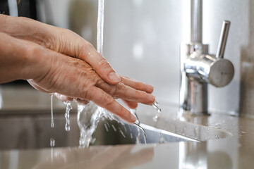 Woman washing her hands to prevent covid