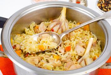 Pilaf with rice and meat in saucepan.