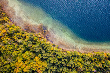 Autum Fall Top view from Drone of Lake Tegernsee and colorful Forest with trees. Lake Shore in bavaria