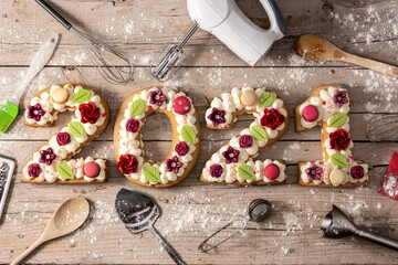 2021 cake decorated with flowers on wooden background.