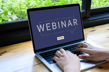 Person using a laptop computer for online training webinars. E-learning browsing connection and cloud online technology webcast concept. Laptop mockup with clipping path on screen
