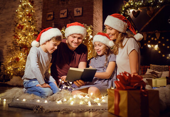 A family reads a book in a room in Christmas.