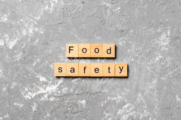 food safety word written on wood block. food safety text on table, concept