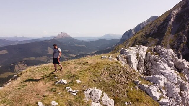 man on the top of a mountain, shot with drone