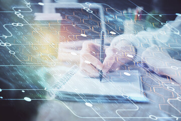 Multi exposure of writing hands on background with data solution hologram. Technology concept.