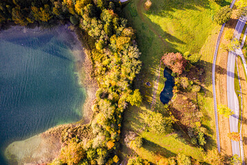 Autum Fall Top view from Drone of Lake Tegernsee and colorful Forest with trees. Lake Shore in bavaria