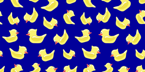 Seamless pattern with yellow toy ducks on a blue background.