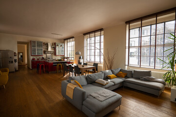 Interior of modern design open space living room in elegant luxury apartment with wide windows.
