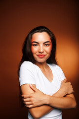 Obraz premium pretty girl happy posing: brunette on brown background, lifestyle people concept