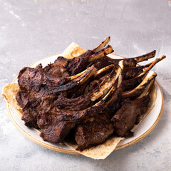 Grilled lamb chops on a plate. Grilled Mutton