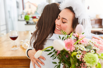 Obraz na płótnie Canvas Girlfriend congratulates bride at wedding or hen party with hug