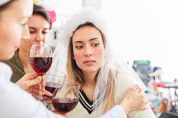 Friends comfort sad and disappointed bride on hen party