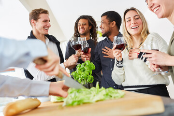 Cutting a salad with a knife for eating together with friends in a shared apartment