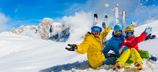 Skiing family enjoying winter vacation on snow in sunny cold day in mountains and fun. San Martino...