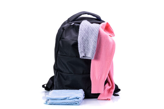 Black backpack and clothes for travel and tourism On a white background