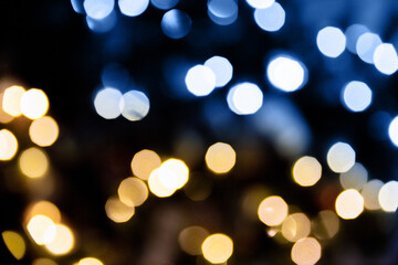 Christmas lights. Bokeh glows on a dark background. Christmas garlands with a blurred focus in the...