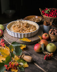 Baking background with raw traditional classic apple pie, bake  ingredients and utensils. Homemade  cake surrounded by fresh fruits