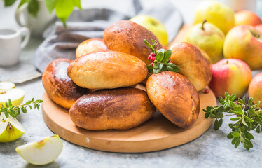 Ready-made baked pies (pirogi) with apple. Traditional russian cuisine.