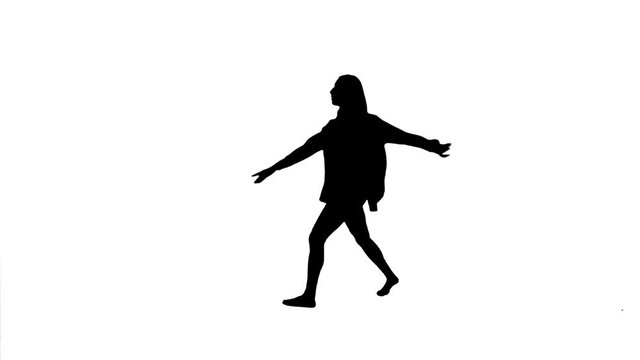 Silhouette. Professional dancer performs over white background.