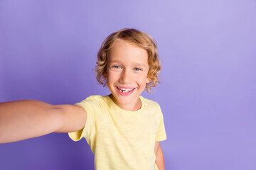 Photo of charming kid boy make self portrait wear casual style clothes isolated over violet color background